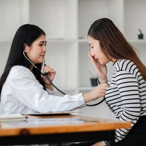 Medical professional performing a SANE exam to collect evidence for a legal case.
